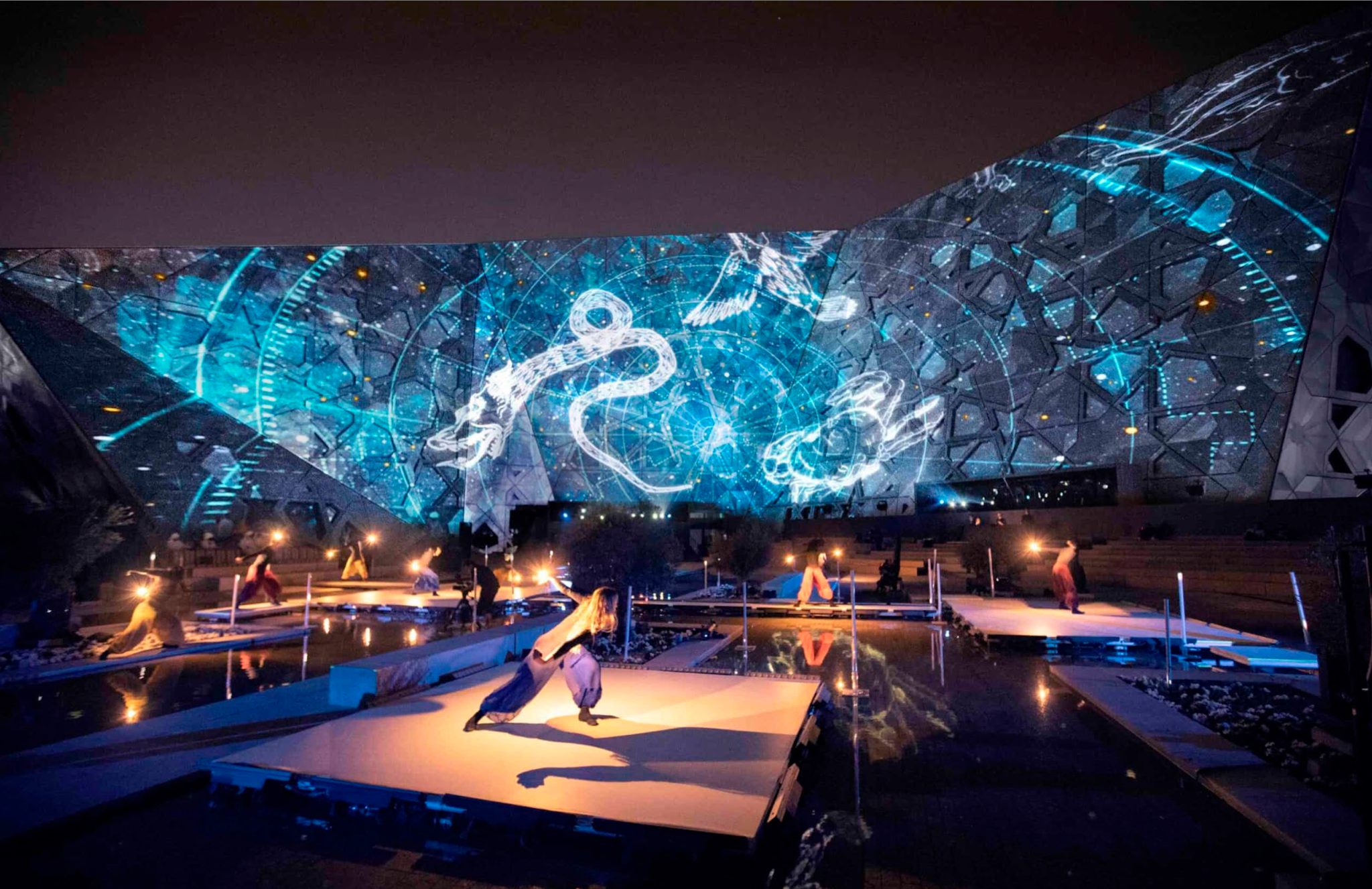 Kuwait Calling: dancers surrounded by blue architectural projections