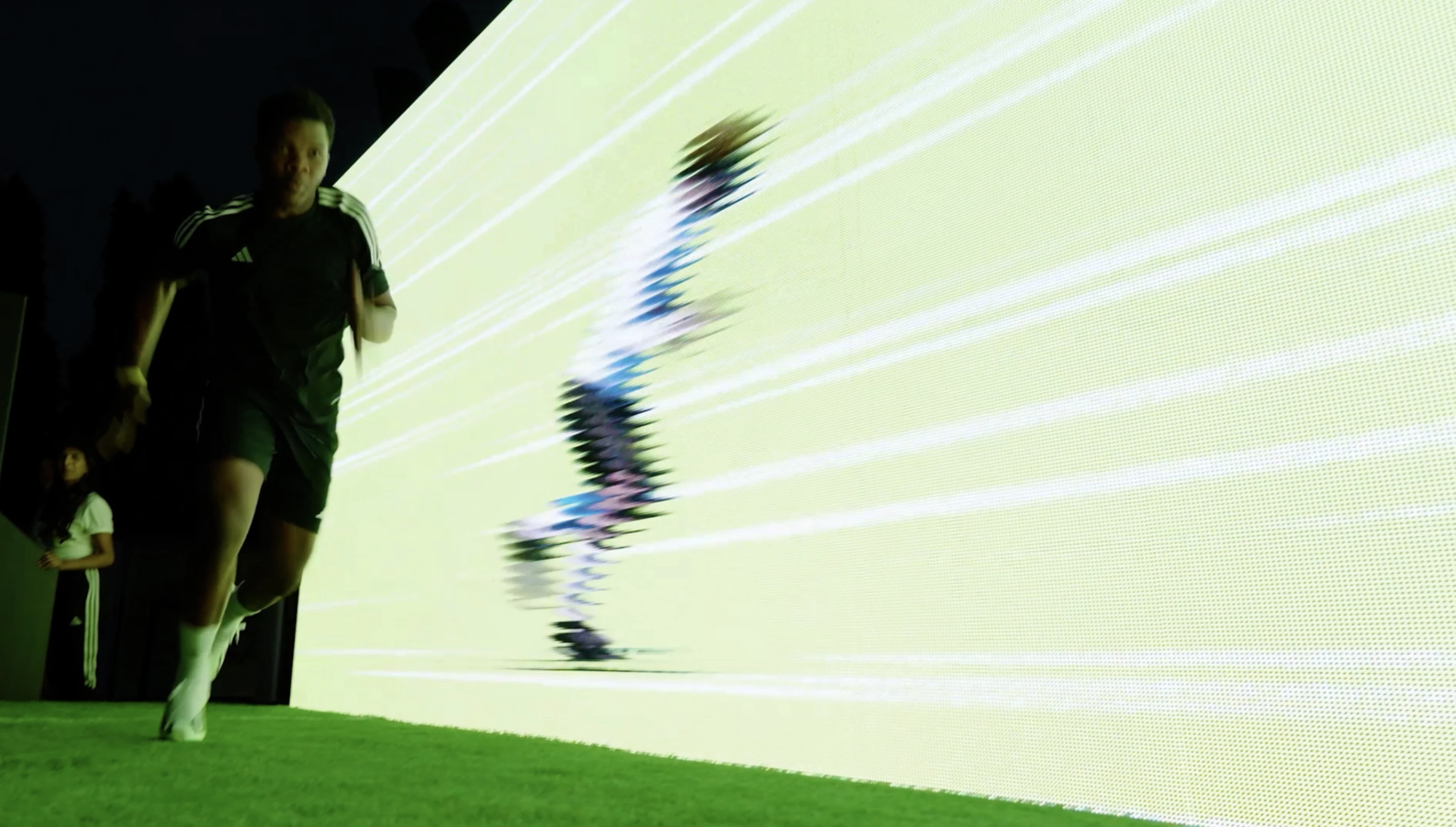 A runner on green turf races beside a responsive digital figure