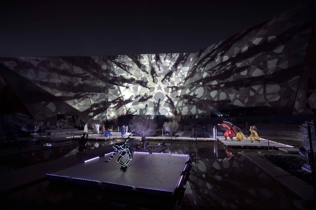 Kuwait Calling: performers beneath monochrome projected forms